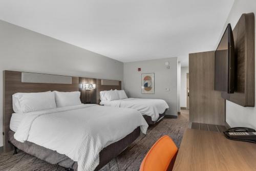 a hotel room with two beds and a flat screen tv at Holiday Inn Express Destin E - Commons Mall Area by IHG in Destin