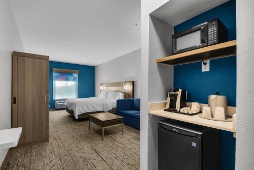 a hotel room with a bed and a bathroom at Holiday Inn Express Destin E - Commons Mall Area by IHG in Destin