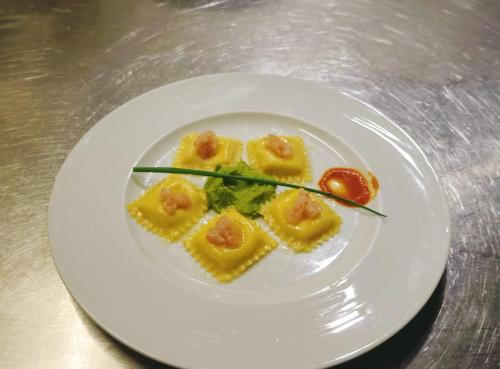 a white plate with food on a table at Tenuta Terre di Bosco Oasi di Relax nel Cilento in San Giovanni a Piro