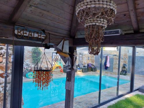 a swimming pool in a building with a large window at Aspen in Kamenný Újezd
