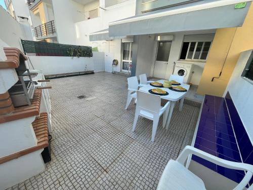 a balcony with a table and chairs in a room at Rosas no Lagar in Vila Nova De Cacela
