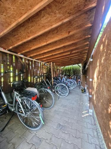 a group of bikes parked under a wooden ceiling at Villa Jedynak in Świnoujście