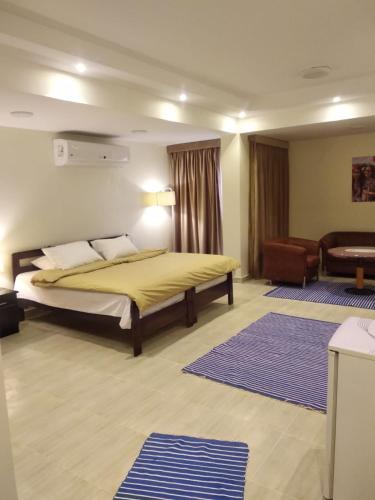 a bedroom with a bed and a chair and a couch at Cairo international Scout House in Cairo