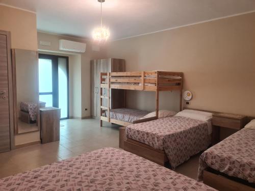 a bedroom with two beds and a bunk bed at Agriturismo Cara Terra Lucana in Chiaromonte