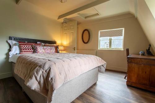 a bedroom with a large bed and a window at Next to Bath Abbey & Roman Baths - Gorgeous Georgian House in Bath