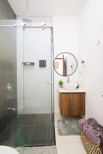 a bathroom with a glass shower and a sink at Natural Arenas 47 ! in Herradura