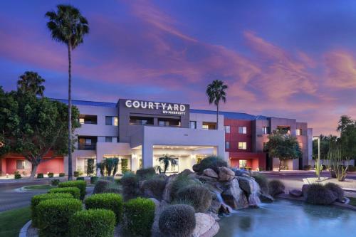 a building with a fountain in front of a building at Courtyard Scottsdale North in Scottsdale