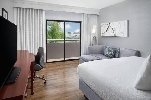 a hotel room with a bed and a desk and chair at Courtyard Scottsdale North in Scottsdale