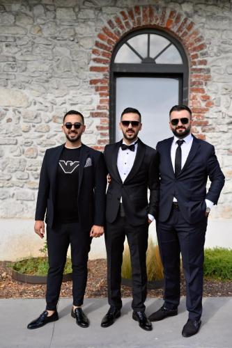 three men in tuxedos standing in front of a building at Fırat Ceylan in Beylikduzu