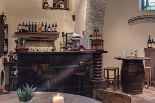 a bar with a counter and some bottles of alcohol at Convento San Bartolomeo in Abbadia San Salvatore