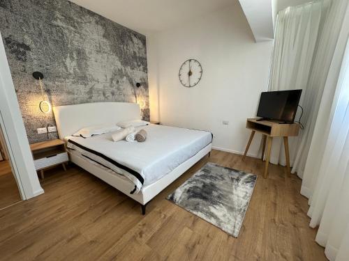 a bedroom with a bed and a clock on the wall at luxury 2 BD by dizingof near the beach in Tel Aviv