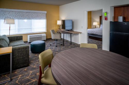 a hotel room with a table and a bed at Holiday Inn Hotel & Suites Beckley by IHG in Beckley