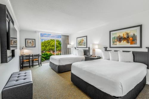 a hotel room with two beds and a window at The Ridge Hotel in Lake Geneva