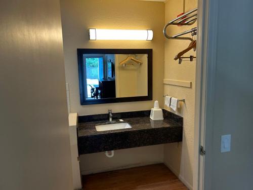 a bathroom with a sink and a mirror at Blue Star inn in Lafayette