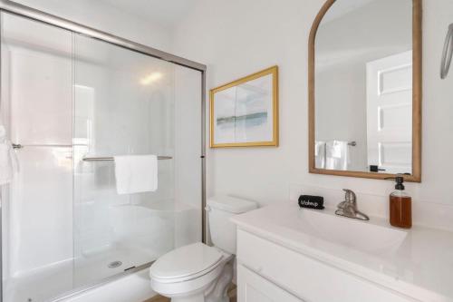 a white bathroom with a shower and a toilet at Panoramic Lake Views, Free Silver Dollar City Tickets, Stunning Decor in Kimberling City