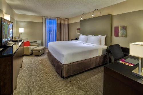 a hotel room with a large bed and a flat screen tv at Crowne Plaza - Chicago West Loop, an IHG Hotel in Chicago