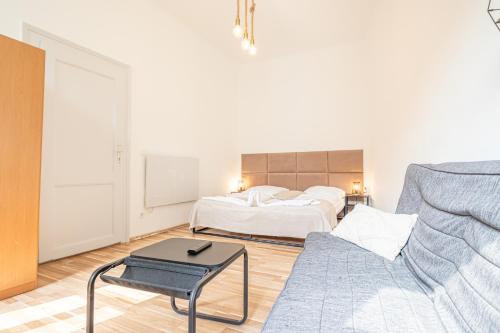 a living room with a bed and a couch at Inviting Economy 1BR Apt. with the best Location in Vienna
