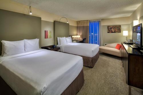 a hotel room with two beds and a television at Crowne Plaza - Chicago West Loop, an IHG Hotel in Chicago