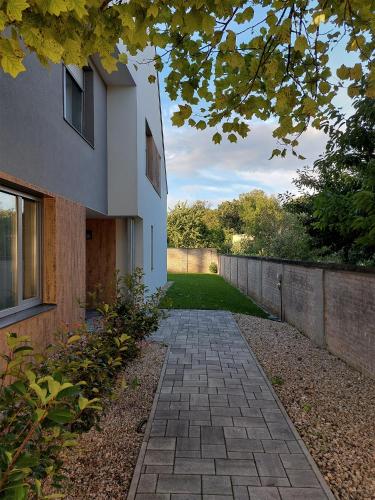 a brick walkway in front of a house at Linden Apartman 106 - Adults Only in Mosonmagyaróvár