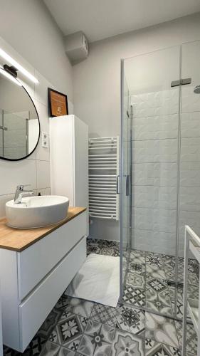 a bathroom with a sink and a glass shower at Linden Apartman 106 - Adults Only in Mosonmagyaróvár