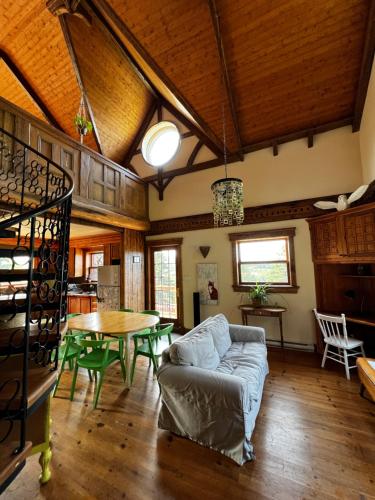 a living room with a couch and a table at Chalet Epicea in Sainte-Anne-des-Monts