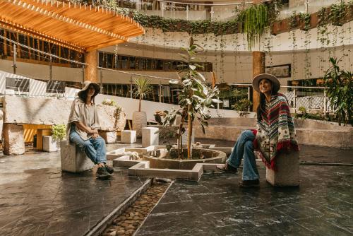 two women sitting in chairs in a building at Hacienda del Valle Sagrado in Urubamba