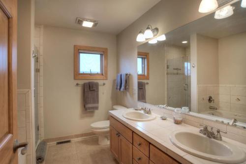 a bathroom with two sinks and a toilet and a mirror at RGC-4D South Fork in South Fork