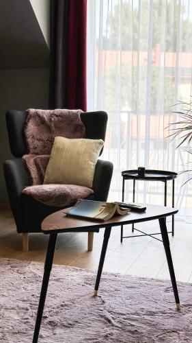 a living room with a couch and a coffee table at Linden Apartman 107 GLAMOUR in Mosonmagyaróvár