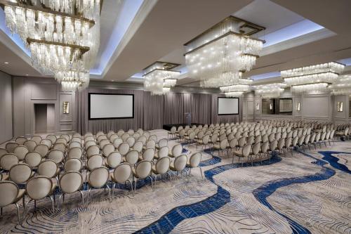 a conference room with rows of chairs and chandeliers at JW Marriott Savannah Plant Riverside District in Savannah