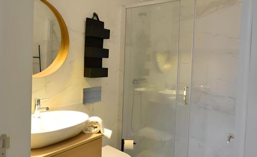 a bathroom with a sink and a glass shower at Porto Pool Spot in Porto