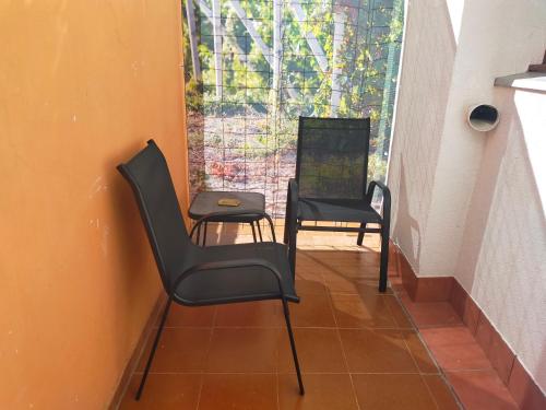 two chairs and a table in a room at Las Mañanitas in Tafalla