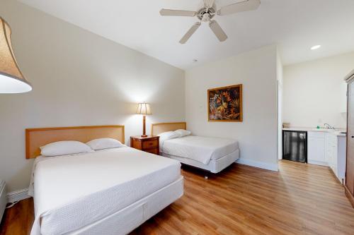a bedroom with two beds and a ceiling fan at Port of the Islands A101 in Naples
