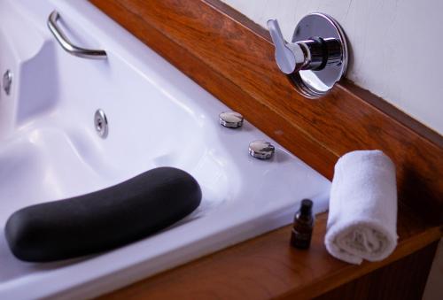 a bathroom with a sink with a towel on it at Pousada Suiça Mineira Centro in Monte Verde