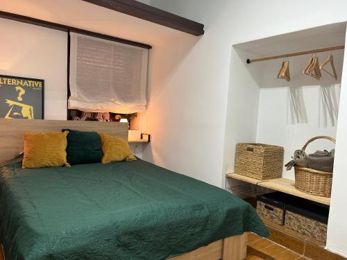 a bedroom with a green bed and a window at Private apartment in the Old Town "Center&Beach" in Benidorm