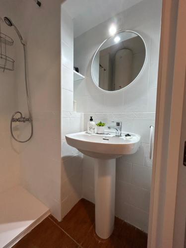 a white bathroom with a sink and a mirror at Private apartment in the Old Town "Center&Beach" in Benidorm