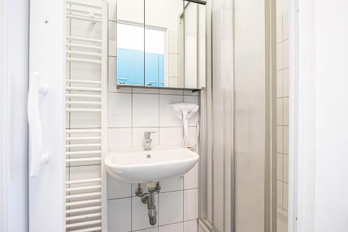 a bathroom with a sink and a mirror at Breathtaking 2BR Apt Modern Design/Near Schönnbrunn in Vienna