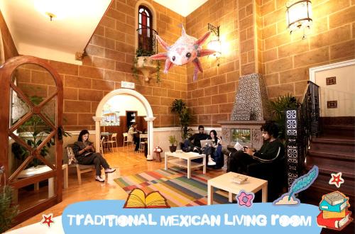 a group of people sitting in a room at Hostal Fungi Casa Rosa in Mexico City