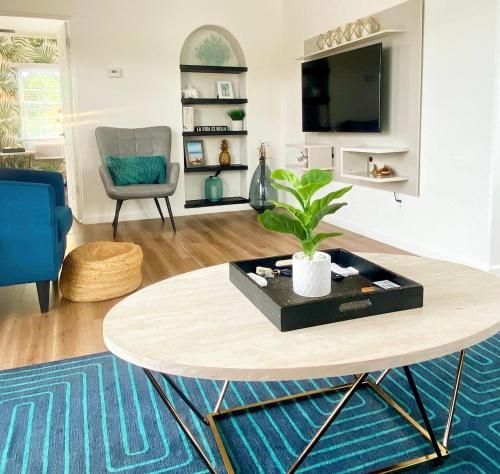 a living room with a table and a chair at Crown Point Home w/ Cowboy Pool 2 Blocks to Bay in San Diego