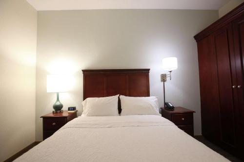 a bedroom with a large bed with two lamps on tables at Hampton Inn Beckley in Beckley