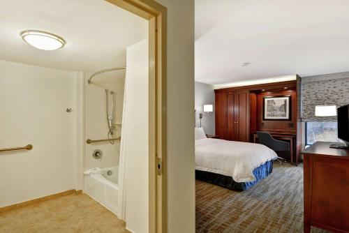 a hotel room with a bed and a bathroom at Hampton Inn Beckley in Beckley