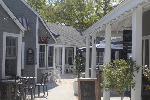 a patio with tables and chairs in a restaurant at Exceptional New Seabury Mews Property in Mashpee