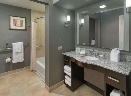 a bathroom with a sink and a mirror at Homewood Suites by Hilton Chicago - Schaumburg in Schaumburg