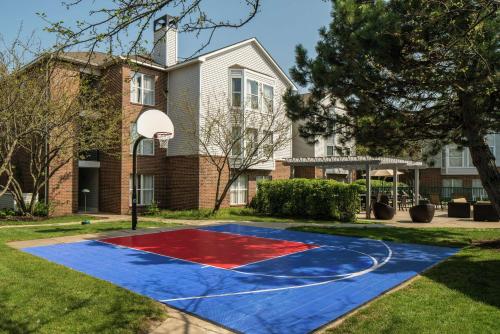 a basketball court in front of a house at Homewood Suites by Hilton Chicago - Schaumburg in Schaumburg