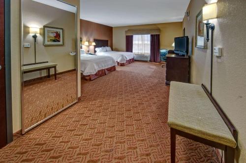 a hotel room with two beds and a television at Hampton Inn & Suites Corsicana in Corsicana