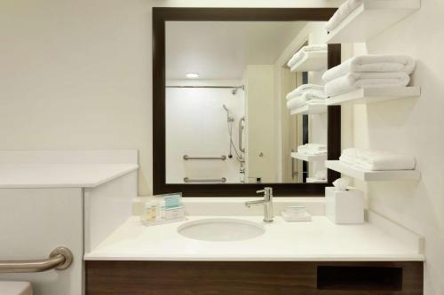 a bathroom with a sink and a mirror at Hampton Inn and Suites Springdale in Springdale