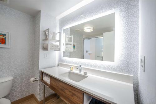 a bathroom with a sink and a mirror at Hampton Inn & Suites Memphis East in Memphis