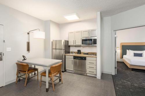 a kitchen with a table and chairs in a room at Homewood Suites by Hilton New Orleans in New Orleans