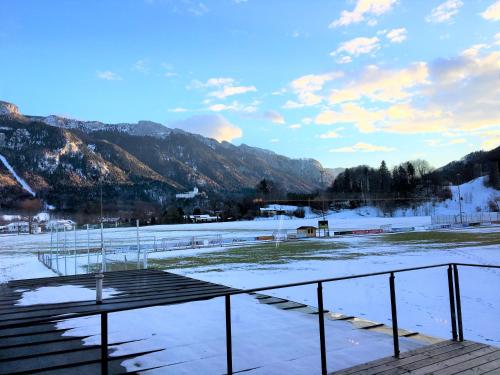 a snow covered field with mountains in the background at KampenZeit Loft mit traumhaftem Panoramablick in Aschau im Chiemgau