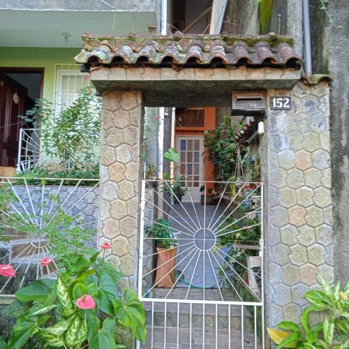 een huis met een poort met een raam bij Pertinho da Mata Kitnete in Cachoeiras de Macacu