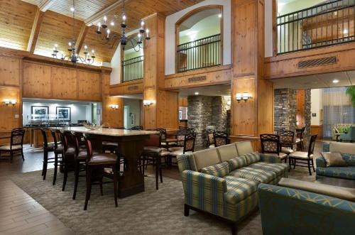 a lobby with a table and chairs and a bar at Hampton Inn & Suites Charlotte/Pineville in Charlotte